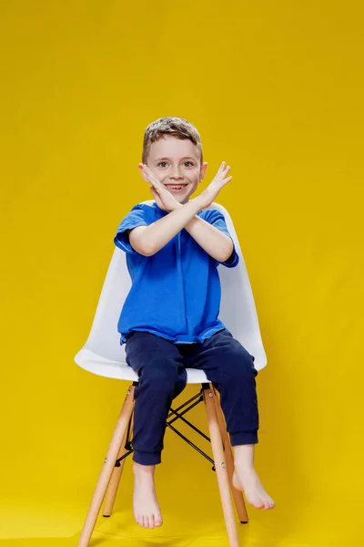Mały Chłopiec Przedszkolu Niebieskiej Koszulce Patrzy Kamerę Skrzyżowanymi Rękami Pokazuje — Zdjęcie stockowe