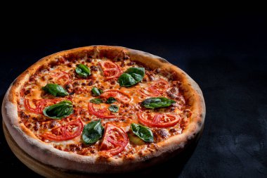 Delicious fragrant pizza with mozzarella, tomatoes and basil with tomato sauce - Margherita.