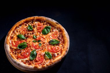 Delicious fragrant pizza with mozzarella, tomatoes and basil with tomato sauce - Margherita.