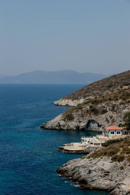 View of the Villa on the seashore. Rocky shore with a house