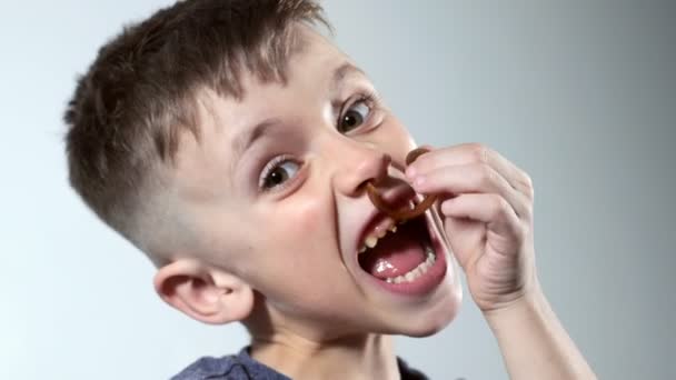 Little Boy Opening Sweets Taking Pastila His Mouth While Sitting — Vídeos de Stock