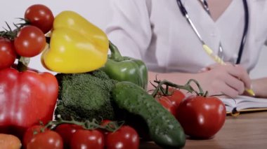 Nutritionist writing a prescription for a patient's health at his desk.