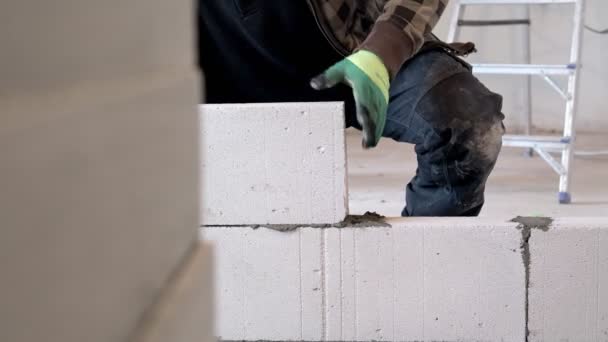 Builder Places Block Construction Wall — Video