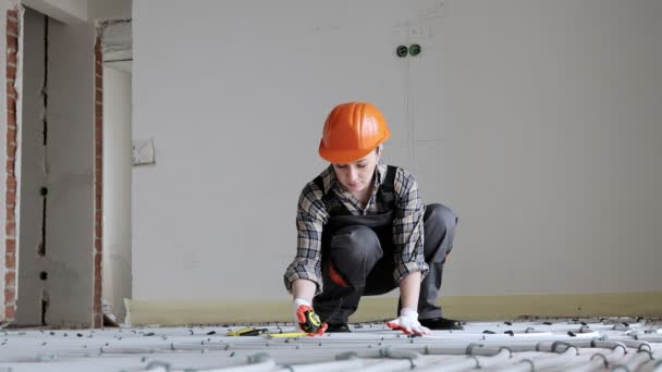 Female Construction Worker Checks Installation Warm Floor Tape Measure Construction — Stock videók