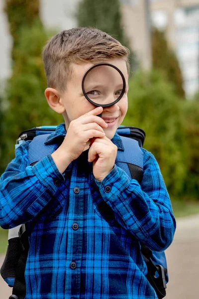 Schoolboy Looking Magnifying Glass Surprised Expression Squinting His Eyes — Stock Photo, Image
