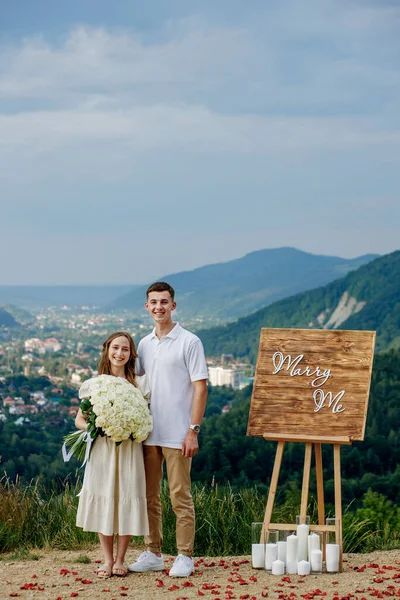 Portrait of a young couple after a marriage proposal in the mountains.