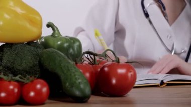 Nutritionist writing a prescription for a patient's health at his desk.