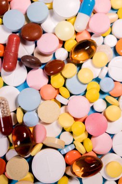 Background with the many colorful different capsules and pills. The concept of medical treatment.