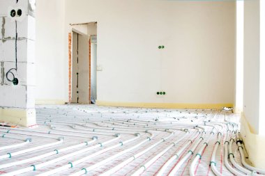 Installation of underfloor heating pipes for water heating. Heating systems. Pipes for underfloor heating