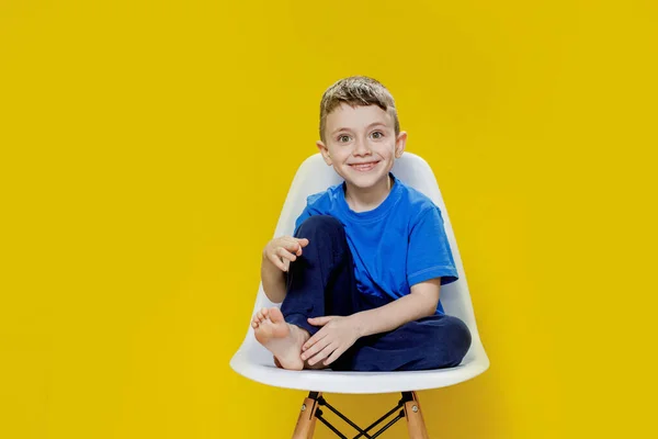 Wesoły Mały Chłopiec Siedzi Żółtym Krześle Jasny Zabawny Portret — Zdjęcie stockowe
