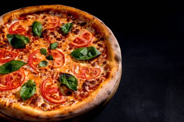 Delicious fragrant pizza with mozzarella, tomatoes and basil with tomato sauce - Margherita.