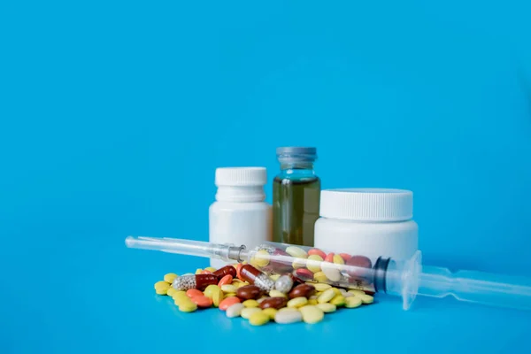 Pharmaceutical preparation, medicine in jars, pills in syringe for injection. Treatment concept.