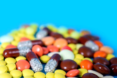 Many colorful different medicines and pills on top. The concept of medical treatment.