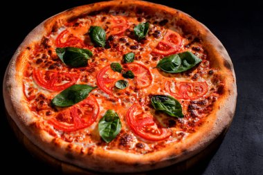 Delicious fragrant pizza with mozzarella, tomatoes and basil with tomato sauce - Margherita.