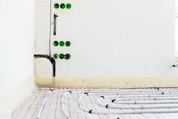 Installation of underfloor heating pipes for water heating. Heating systems. Pipes for underfloor heating