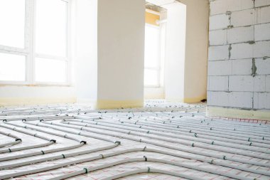 Installation of underfloor heating pipes for water heating. Heating systems. Pipes for underfloor heating