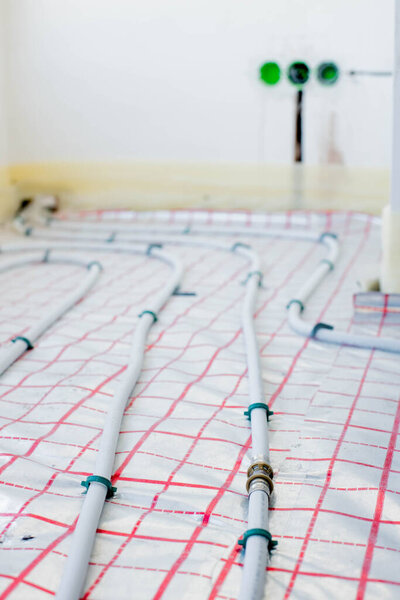 Heating pipes are connected by press fittings. Installation of a warm floor. Hydraulic, plumbing tools
