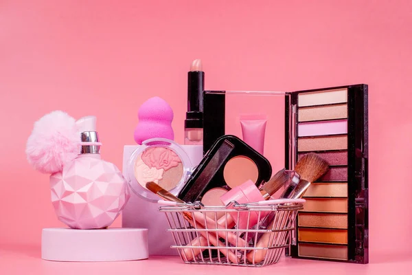Professional makeup tools. Makeup products on pink background. A set of various products for makeup.