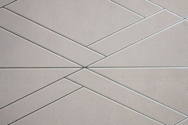 Bej renkli soyut üçgen geometrik doku, tekrarlama ve çizgilerle sıralanmış ve istiflenmiş.