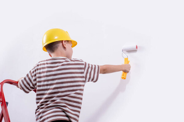 Boy painting wall during home renovation