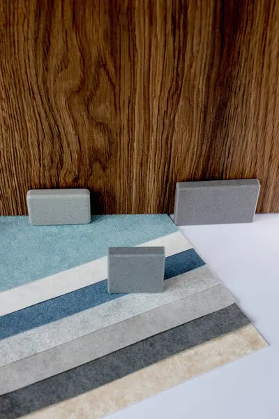 Samples of materials for interior design. Fabric wallpaper, samples of artificial stone, wood.