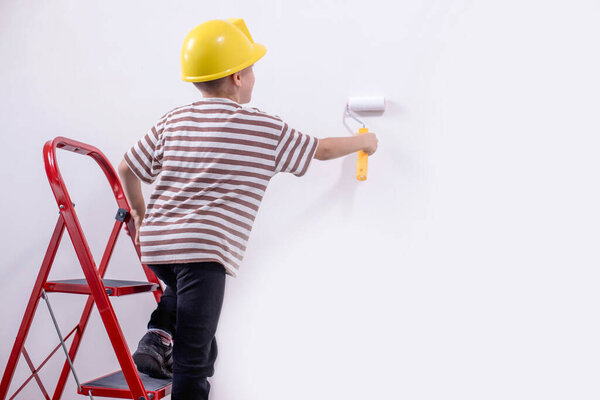 Boy painting wall during home renovation