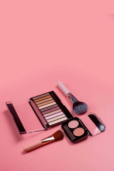 Professional makeup tools. Products for makeup on pink background. A set of various products for makeup
