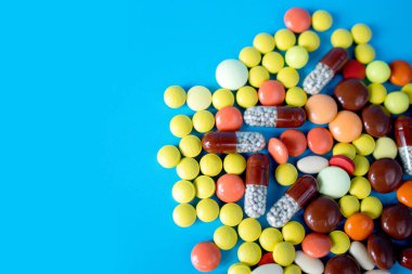 Many colorful different medicines and pills on top. The concept of medical treatment.