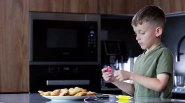 Sadece çocuk mutfakta kurabiye yapıyor.