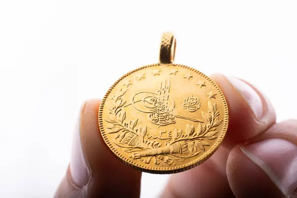 stock image Turkish Ottoman style gold coin in hand on white background