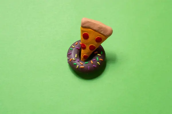 Piece of pizza Icon donut icon on green paper. Cooking concept