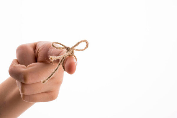 Hand tied with a thread like a ribbon on a white background