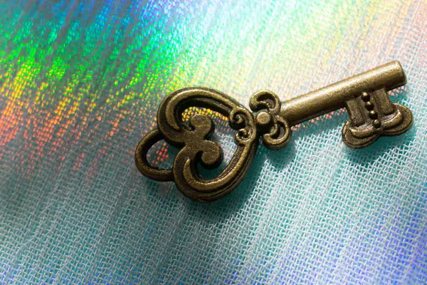 Vintage key. .Antique key. Retro key on colorful fabric background