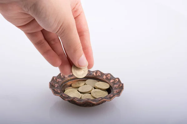 Hand Giving Away Money Metal Bowl Stock Image