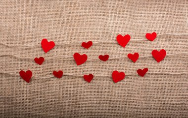 Love concept with heart shaped papers on linen threads clipart
