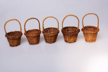 Little size Empty wicker baskets on  white background clipart