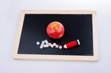 Back to school theme with a red apple and board clipart