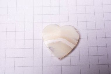 White heart icon  on checked paper for love  and valentine concept clipart