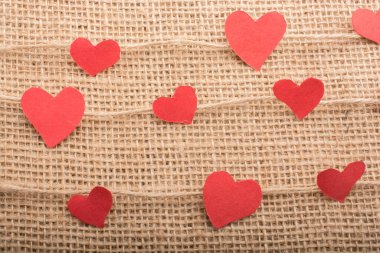 Love concept with heart shaped papers on linen threads clipart