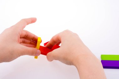 Beyaz arkaplanda renkli domino taşıyla el oyunu