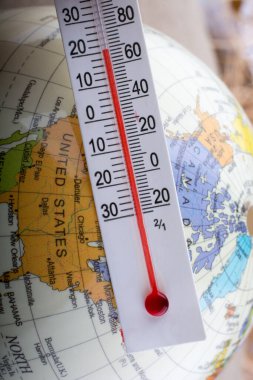 Üzerinde küçük bir modeli dünya termometre yerleştirilmiş