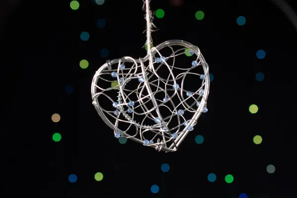 stock image Heart shaped metal cage on a bokeh light background