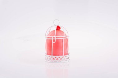 Beyaz renk kuş evi metal çubuklarla küçük kırmızı balon yerleştirilir