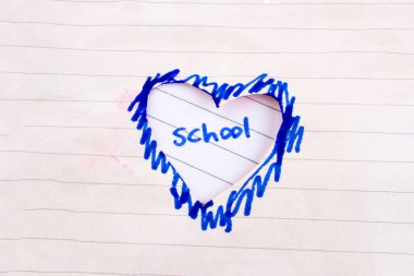 Hole made in lined paper on the form of a heart clipart