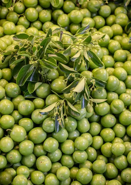 stock image Green unripe plums in bazaar market place