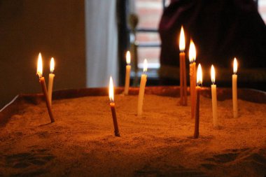 Bir kilise koyu arka plan üzerinde yanan mumlar