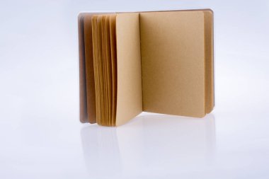 Kahverengi renk defter ile beyaz bir arka plan üzerine açık sayfaları