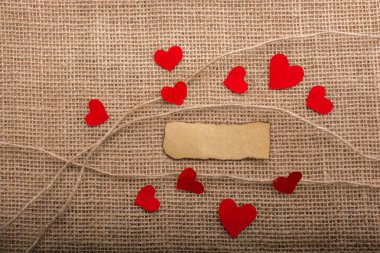 Love concept with heart shaped papers on linen threads clipart