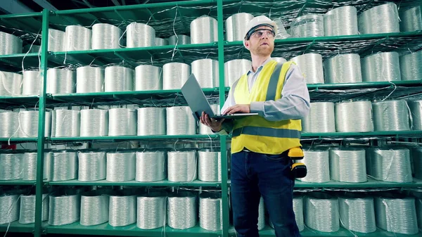 Male worker is doing inventory of fiberglass in the storage. 4K
