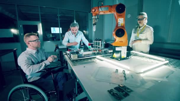 Engineer Wheelchair His Colleagues Discussing Robots — Vídeo de Stock